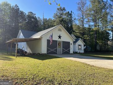 Charming single-story home with a welcoming front entrance, attached garage and a well-manicured lawn at 127 Jenny Rd, Grantville, GA 30220