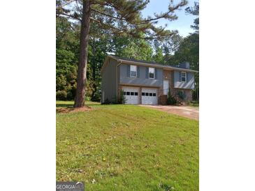 Charming two-story home with a two-car garage and well-maintained front yard at 4616 Hamlet Se Walk, Conyers, GA 30094