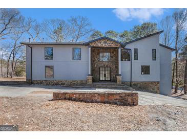 Stunning modern home featuring unique stone accents and a distinctive architectural design at 1620 Saddle Ridge Way, Sandy Springs, GA 30350