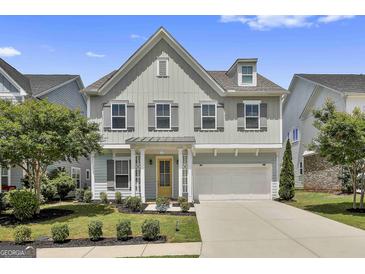Charming two-story home with well-manicured lawn, two-car garage, neutral paint, and a welcoming front porch at 307 Owenberg Trce, Peachtree City, GA 30269
