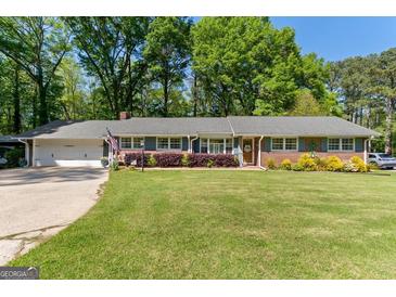 Charming brick home with a well-manicured lawn and a two-car garage, perfect for suburban living at 118 Duvall Dr, Stockbridge, GA 30281