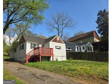 Charming home features a front-facing porch and mature landscaping, creating a welcoming curb appeal at 2016 Conrad Se Ave, Atlanta, GA 30315