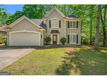 Charming two-story home featuring a well-maintained lawn, two-car garage, and traditional architectural details at 542 Creek Stone Ln, Stone Mountain, GA 30087