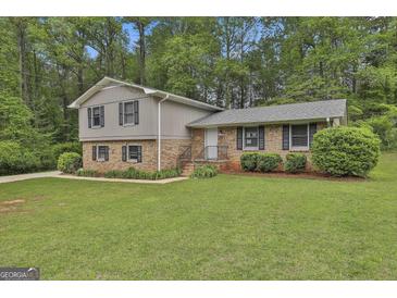 Charming split-level home featuring a brick facade, gray siding, and a well-manicured lawn at 269 Malone Cir, Fairburn, GA 30213