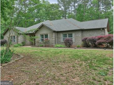Charming brick home with a well-manicured lawn and lush landscaping at 678 Oak Grove Rd, Mcdonough, GA 30253
