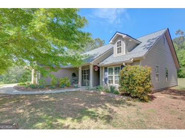 Charming home featuring manicured landscaping and traditional architectural details under a clear blue sky at 103 Fuller Ct, Grantville, GA 30220
