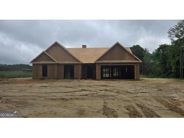 Exterior view of an unfinished house with a garage and wood construction material at 3229 Broadnax Mill Rd # 4, Loganville, GA 30052