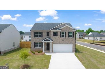 Charming two-story brick home with a well-manicured lawn and a two-car garage at 572 Whitman Ln # 19, Stockbridge, GA 30281