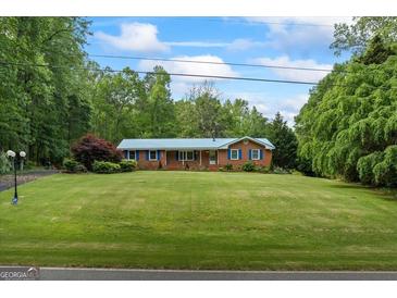 Charming single-story home with a well-manicured lawn and lush landscaping at 725 & 761 School Road, Hampton, GA 30228