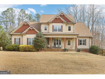 Inviting two-story home with a charming front porch and well-manicured landscaping at 108 Turnberry Trce, Sharpsburg, GA 30277