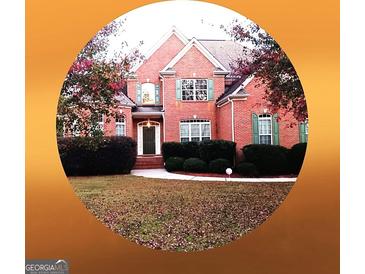 Traditional two-story brick home with a manicured lawn and mature landscaping at 30 Cynthia Ct, Fayetteville, GA 30215