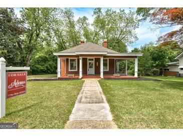 Charming single story house with a quaint front porch and well-manicured lawn at 19 Mcdonough St, Hampton, GA 30228