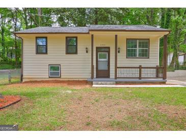 Charming home featuring a covered front porch, neutral siding, and well-maintained landscaping at 6454 Boca Grande Blvd, Forest Park, GA 30297