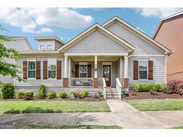 Charming home featuring a welcoming front porch, well-manicured landscaping, and classic architectural details at 175 Campaign Trl, Fayetteville, GA 30214