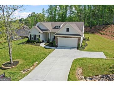 Charming single-Gathering home with manicured lawn, beautiful landscaping, and a two car garage at 2124 Gaddis Rd, Canton, GA 30115