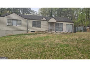 Quaint single-story home with a spacious front yard, showing its potential for landscaping at 4064 Sunset Sw Dr, Atlanta, GA 30331