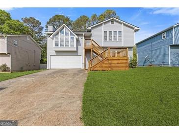 Charming home with a deck, garage, and lush lawn at 4811 Nevilly Way, Marietta, GA 30066