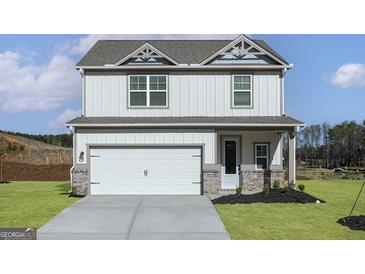 Charming two-story home featuring a white exterior, a two-car garage, and a well-manicured lawn at 432 Cantrell Drive, Dallas, GA 30157