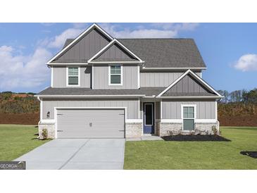 Charming two-story home featuring a two-car garage and a well-manicured lawn at 412 Cantrell Drive, Dallas, GA 30157