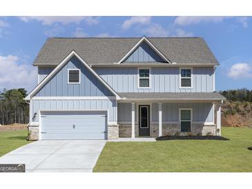 Charming two-story home with a light blue exterior, attached garage, and well-manicured front lawn at 446 Cantrell Drive, Dallas, GA 30157