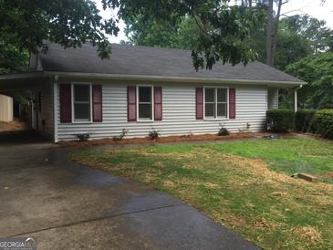 Charming single story home with red shutters and a well manicured front yard at 3875 Grand Prix St, Cumming, GA 30041