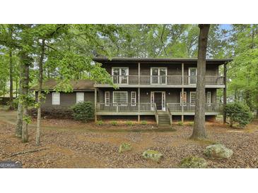 Charming two-story home featuring a double balcony and lush, mature landscaping at 101 Longer Dr, Peachtree City, GA 30269