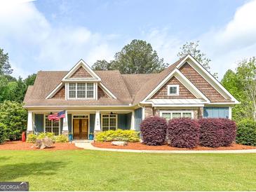 Charming home featuring a manicured lawn and beautiful landscaping at 106 Tullamore Trl, Tyrone, GA 30290