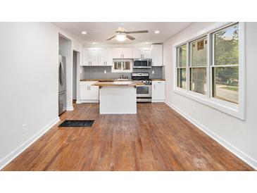 Modern kitchen features white cabinets, stainless steel appliances, wood countertops, and an island at 2952 Diana Sw Dr, Atlanta, GA 30315