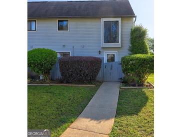 Charming townhome with manicured front yard and inviting walkway at 288 Country Club Dr, Jonesboro, GA 30238