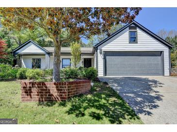 Charming home with white siding, dark trim, and a well-manicured front yard at 3336 Country Creek Nw Dr, Kennesaw, GA 30152