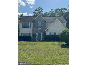 Traditional two-story home with stone accents, blue shutters, and a well-manicured lawn at 117 Rendition Dr, Mcdonough, GA 30253