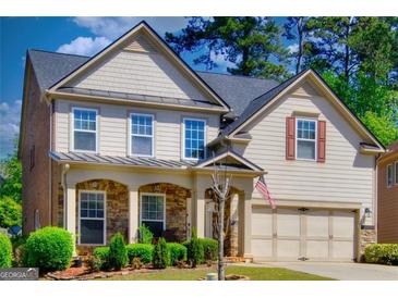 Charming two-story home featuring a stone porch, gray siding, and a well-manicured front yard at 5845 Princeton Run Trl, Tucker, GA 30084