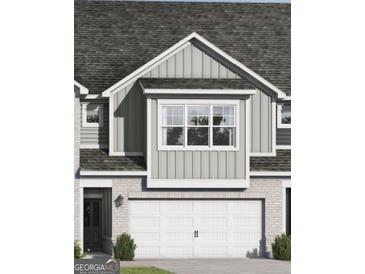 Charming home exterior with a white garage door, gray siding and stone details at 2278 Santa Fe St, Morrow, GA 30260