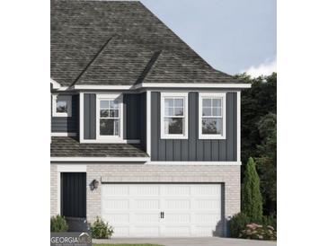 Charming home exterior featuring a two-car garage and vertical siding details at 2280 Santa Fe St, Morrow, GA 30260