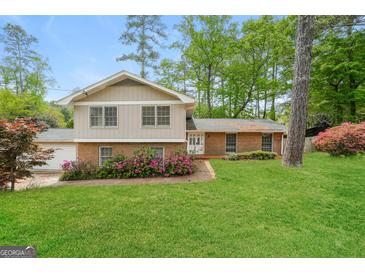 Charming two-story home with brick accents, lush landscaping, and a well-maintained lawn at 543 Tahoe Cir, Stone Mountain, GA 30083