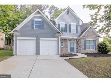 Charming two-story home features a two car garage, stone accents, and craftsman details at 3313 Bethesda Ter, Acworth, GA 30101