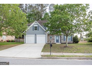 Charming two-story home featuring a stone facade, gray siding, well-maintained lawn, and a two car garage at 3313 Bethesda Ter, Acworth, GA 30101