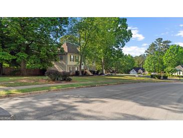 Charming two-story home with traditional architecture and a lush, green lawn at 1401 Aberdeen Ct, Mcdonough, GA 30253