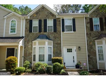 Charming townhome with stone accents, neat landscaping and a welcoming front door at 2566 Summit Cove Dr, Duluth, GA 30097