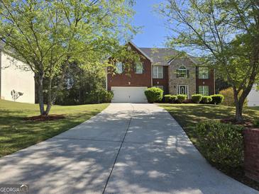 Two-story brick and stone home with a long driveway and mature trees at 247 Water Oak Ln, Jonesboro, GA 30238