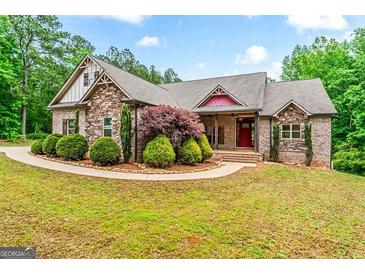 Charming brick home featuring manicured landscaping and a welcoming front porch at 1233 Butler Bridge Rd, Mcdonough, GA 30252