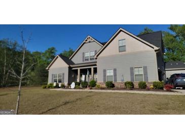 Charming gray two-story home featuring well-maintained landscaping and a welcoming front porch at 101 Ruby Ln, Mcdonough, GA 30252