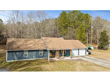 Charming single-story home with a well-maintained yard and an attached two-car garage at 105 Meadow Spring'S Ct, Locust Grove, GA 30248