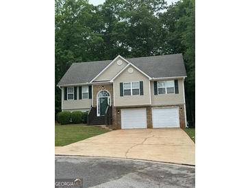 Charming two-story home featuring a two-car garage, landscaped front yard, and traditional design at 140 Clover Valley Dr, Covington, GA 30016