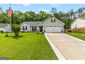 Charming home featuring manicured lawn, gray siding, black shutters, and a two-car garage at 12 Connie Trl, Grantville, GA 30220