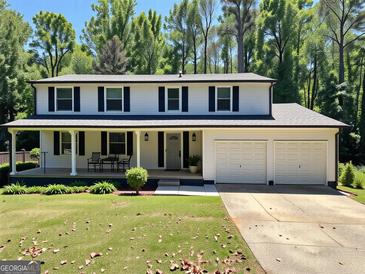 Charming two-story home with a welcoming front porch and well-manicured lawn at 2691 Old South Dr, Jonesboro, GA 30236