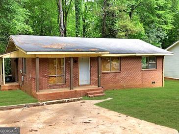 Cozy brick home with a small front yard and covered porch at 6186 Green Acres Sw Dr, Covington, GA 30014