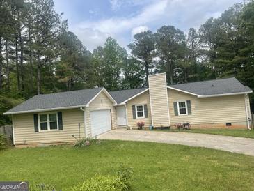 Charming single-story home with a well-maintained lawn and a classic suburban aesthetic at 625 Locust Rd, Locust Grove, GA 30248