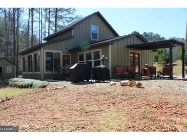Inviting home with a covered patio, grill, and outdoor seating perfect for entertaining at 460 Morgan Mill Rd, Brooks, GA 30205