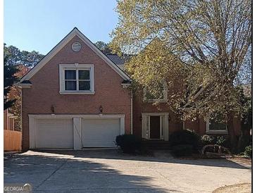 Charming brick home featuring a two-car garage and a meticulously maintained front yard at 4746 Chamblee Dunwoody Rd, Atlanta, GA 30338